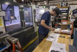 Eagle Plastics Machinist performing a measure check in the warehouse